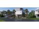 Charming elevated beach home showcasing its coastal design with surrounding greenery and landscaping at 615 W Beach Ct, Folly Beach, SC 29439