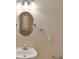 Small bathroom with a pedestal sink and oval mirror at 8604 Fox Hollow Rd, North Charleston, SC 29420