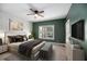 Spacious bedroom with green walls, ceiling fan, and plush carpet at 8604 Fox Hollow Rd, North Charleston, SC 29420