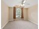 Bright bedroom with arched window, ceiling fan, and neutral carpet at 8604 Fox Hollow Rd, North Charleston, SC 29420