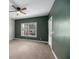 Spacious bedroom with carpeting, ceiling fan, and large window at 8604 Fox Hollow Rd, North Charleston, SC 29420