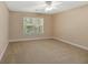 Simple bedroom with window, ceiling fan and neutral carpet at 8604 Fox Hollow Rd, North Charleston, SC 29420