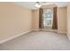 Bright bedroom with arched window, ceiling fan, and neutral carpet at 8604 Fox Hollow Rd, North Charleston, SC 29420