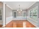 Bright dining room with hardwood floors, crown molding, and large windows at 8604 Fox Hollow Rd, North Charleston, SC 29420