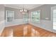 Spacious dining room featuring hardwood floors and elegant chandelier at 8604 Fox Hollow Rd, North Charleston, SC 29420