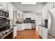 Modern kitchen with white cabinets, granite counters, and stainless steel appliances at 8604 Fox Hollow Rd, North Charleston, SC 29420