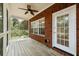 Bright screened porch features a ceiling fan and brick wall at 8604 Fox Hollow Rd, North Charleston, SC 29420