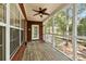 Relaxing screened porch with ceiling fan and wood flooring at 8604 Fox Hollow Rd, North Charleston, SC 29420