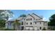 Two-story home with attached garage and landscaping at 945 Fish Camp Rd, Charleston, SC 29492