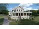 Two-story home with wraparound porch and landscaping at 945 Fish Camp Rd, Charleston, SC 29492