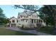 Two-story home with attached garage and landscaping at 945 Fish Camp Rd, Charleston, SC 29492