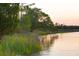 Serene waterfront property with marsh views at sunset at 945 Fish Camp Rd, Charleston, SC 29492