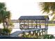Charming waterfront dock with covered seating area at 945 Fish Camp Rd, Charleston, SC 29492