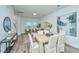 Light-filled dining area with wood table and neutral decor at 1001 Twin Rivers Dr # 65, Wando, SC 29492