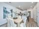 Bright dining room with white chairs and kitchen views at 1001 Twin Rivers Dr # 65, Wando, SC 29492