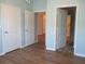 An empty bedroom features wood floors, light blue walls, white trim, and white doors at 1300 Park West Blvd # 1001, Mount Pleasant, SC 29466