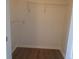 A walk in closet with wood floors features multiple shelves for storing clothing at 1300 Park West Blvd # 1001, Mount Pleasant, SC 29466