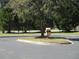 A trash receptacle sits in a green common area featuring mature trees and a well-maintained lawn at 1300 Park West Blvd # 1001, Mount Pleasant, SC 29466