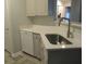 A well lit kitchen is furnished with a dishwasher and sink with updated countertops and cabinets at 1300 Park West Blvd # 1001, Mount Pleasant, SC 29466