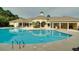 Community pool with a clubhouse and surrounding landscaping at 1300 Park West Blvd # 1001, Mount Pleasant, SC 29466