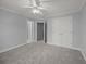 Grey carpeted bedroom with double doors leading to the bathroom at 1333 Chrismill Lane Ln, Mount Pleasant, SC 29466