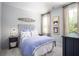 Nautical-themed bedroom with shiplap wall and blue bedding at 140 Maritime Way, Summerville, SC 29485