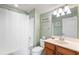 Clean bathroom with tub, toilet and wood vanity at 1589 Pixley St, Charleston, SC 29414