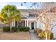 Two-story house with white siding, red brick accents, and a palm tree at 1589 Pixley St, Charleston, SC 29414