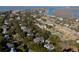 Aerial view of coastal neighborhood with marsh and tennis courts at 1738 Ion Ave, Sullivans Island, SC 29482