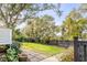 Landscaped backyard with stone pathway, lush greenery, and privacy fence at 1738 Ion Ave, Sullivans Island, SC 29482