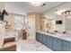 Bathroom with double vanity, walk-in shower, and a large mirror at 1738 Ion Ave, Sullivans Island, SC 29482