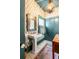 Charming bathroom with pedestal sink, patterned wallpaper, and unique mirror at 1738 Ion Ave, Sullivans Island, SC 29482