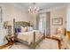 Bedroom with a large bed, chair, and hardwood floors at 1738 Ion Ave, Sullivans Island, SC 29482