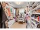 Walk-in closet with custom shelving and a vanity at 1738 Ion Ave, Sullivans Island, SC 29482