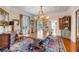 Elegant dining room with large wood table, chandelier, and ornate rug at 1738 Ion Ave, Sullivans Island, SC 29482