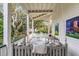 Relaxing porch swing overlooks the backyard and mature trees at 1738 Ion Ave, Sullivans Island, SC 29482