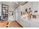 White kitchen with sink, built-in cabinetry, and wood floors at 1738 Ion Ave, Sullivans Island, SC 29482