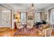 Spacious living room with hardwood floors, ornate chandelier, and antique furniture at 1738 Ion Ave, Sullivans Island, SC 29482