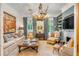 Spacious living room with comfy seating, unique chandelier, and built-ins at 1738 Ion Ave, Sullivans Island, SC 29482