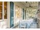 Screened porch with table, chairs, and artwork, offering a relaxing outdoor space at 1738 Ion Ave, Sullivans Island, SC 29482