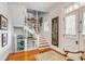 Grand staircase with hardwood floors and antique artwork on the walls at 1738 Ion Ave, Sullivans Island, SC 29482