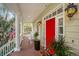 Inviting front entrance with a red door and white columns at 1871 Headquarters Plantation Dr, Johns Island, SC 29455