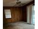 Bedroom with wood paneling, carpet flooring, window, and sliding glass doors at 1972 Green Park Ave, Charleston, SC 29414