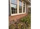 Brick house exterior showcasing a section of the foundation and landscaping at 1972 Green Park Ave, Charleston, SC 29414