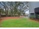 Spacious backyard with a grassy area and mature trees at 2166 Brown Pelican Ln, Charleston, SC 29412