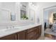Double vanity bathroom with dark brown cabinets and a large mirror at 2166 Brown Pelican Ln, Charleston, SC 29412