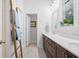 Double vanity bathroom with dark brown cabinets and a large mirror at 2166 Brown Pelican Ln, Charleston, SC 29412
