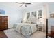 Spacious bedroom with king-size bed, dresser, and large windows at 2166 Brown Pelican Ln, Charleston, SC 29412