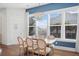 Bright dining room features a rustic farmhouse table with seating for six and a chandelier at 2166 Brown Pelican Ln, Charleston, SC 29412