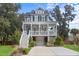Two-story house with gray siding, white porch, and a landscaped lawn at 2166 Brown Pelican Ln, Charleston, SC 29412